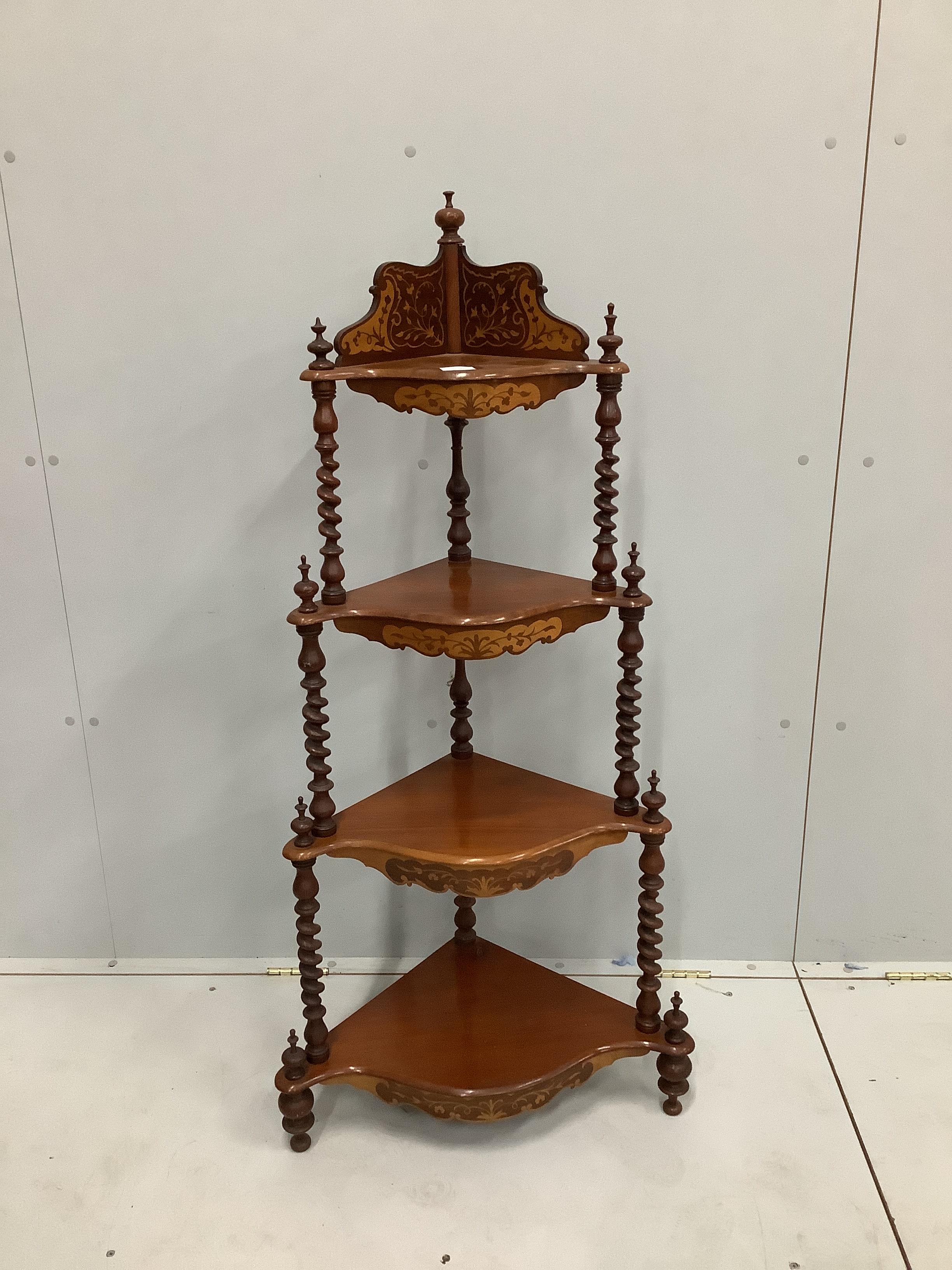 A late Victorian inlaid walnut serpentine four tier corner whatnot, width 62cm, height 129cm